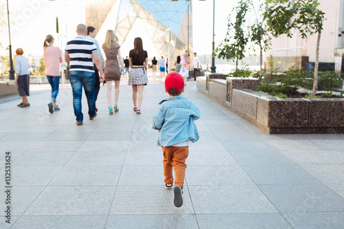 Little boy running on the street photo