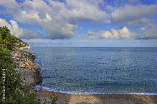 Apula coast,Gargano National Park: Pungnochiuso beach. Vieste,Italy.The bay is bounded by marvellous hills covered with age-old pine trees. photo