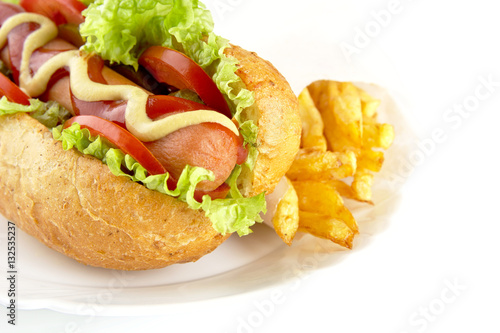 Cropped hot dog with ingredients on plate on white background