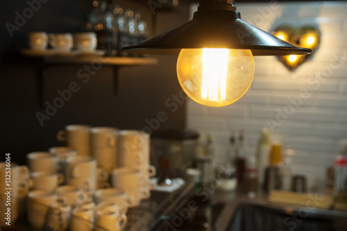 Edison's light bulb and lamp in modern style. Warm tone light bulb lamp. Lamps in coffee shop. Edison's lightbulb in interior.