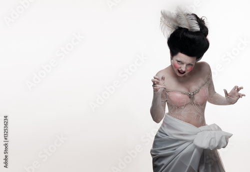 Canvas-taulu emotional actress brunette woman in the role of a vampire on a white background