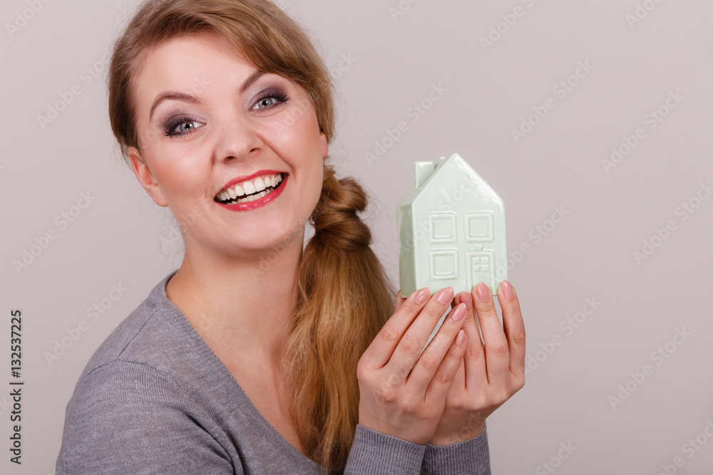 Smiling girl with home symbol. Smiling girl with home symbol.