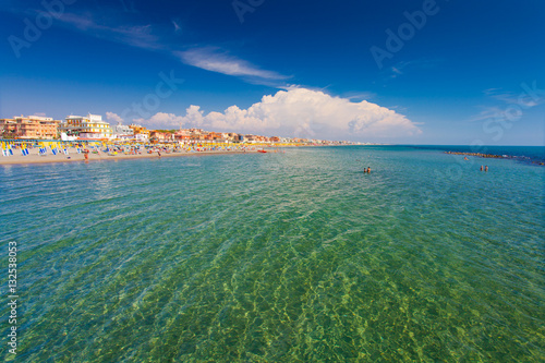 Swimming and relaxing people on the beautiful beach Lido di Ostia ( Lido di Roma), private beach Battistini, Italy.