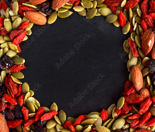 Fotografie, Obraz Nut mix snack with raisins, pumpkin seeds, almonds and goji berries on stone boa