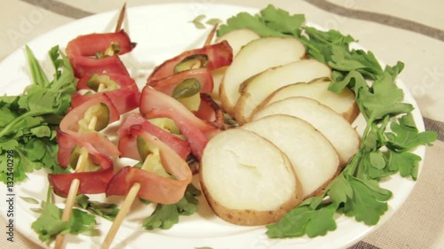 Wallpaper Mural Delicious baked potatoes with bacon and cucumbers on skewers on plate. Slider dolly movement Torontodigital.ca