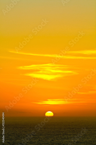 Sunset over the ocean with yellow sky at Arraial do Cabo, Rio de Janeiro, Brazil © Nkt UsrBr