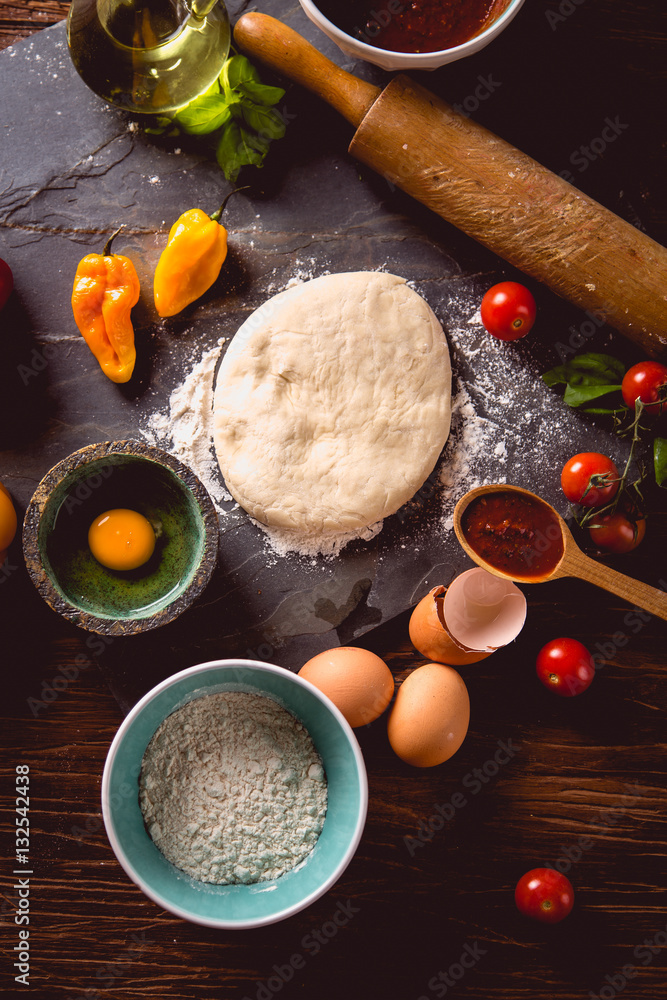 Fototapeta premium Fresh and tasty homemade pizza on wooden table with ingredients
