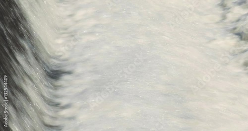 White water fast flowing over a damn on the Carrabassett River in Kingfield, Maine. photo