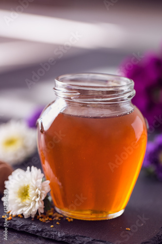 Sweet organic honey in the glass jar.