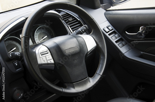 Car steering wheel in the car console. © intararit