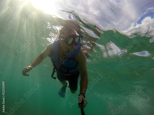 Boy diving snorkeling ocean underwater mask selfie
