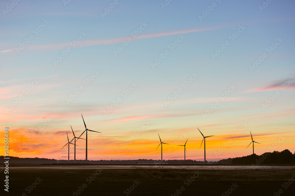 Silhouette of wind turbine on sunset Silhouette of wind turbine on sunset