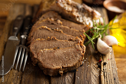 Braised brisket on cutting board photo