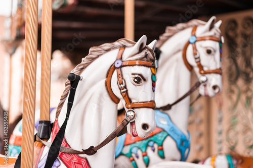 Carousel at a carnival or festival. Decorative ornate horse at a fun fair.