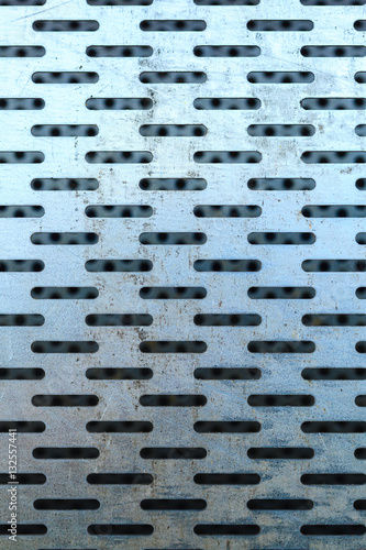 Abstract closeup of steel texture with holes