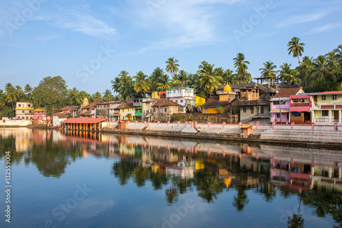 Colorful indian houses on the bank of sacred lake Koti Teertha in Gokarna, India. photo