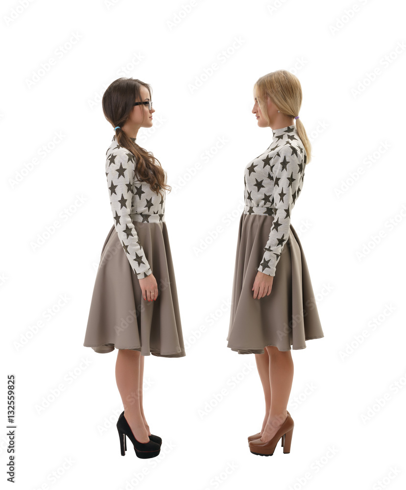 Two women wearing same clothes  isolated on white