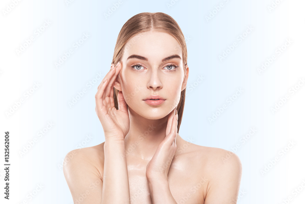 portrait with hands of beautiful, fresh, healthy and sensual girl over blue background portrait with hands of beautiful, fresh, healthy and sensual girl over blue background