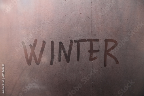 Word winter written on glass