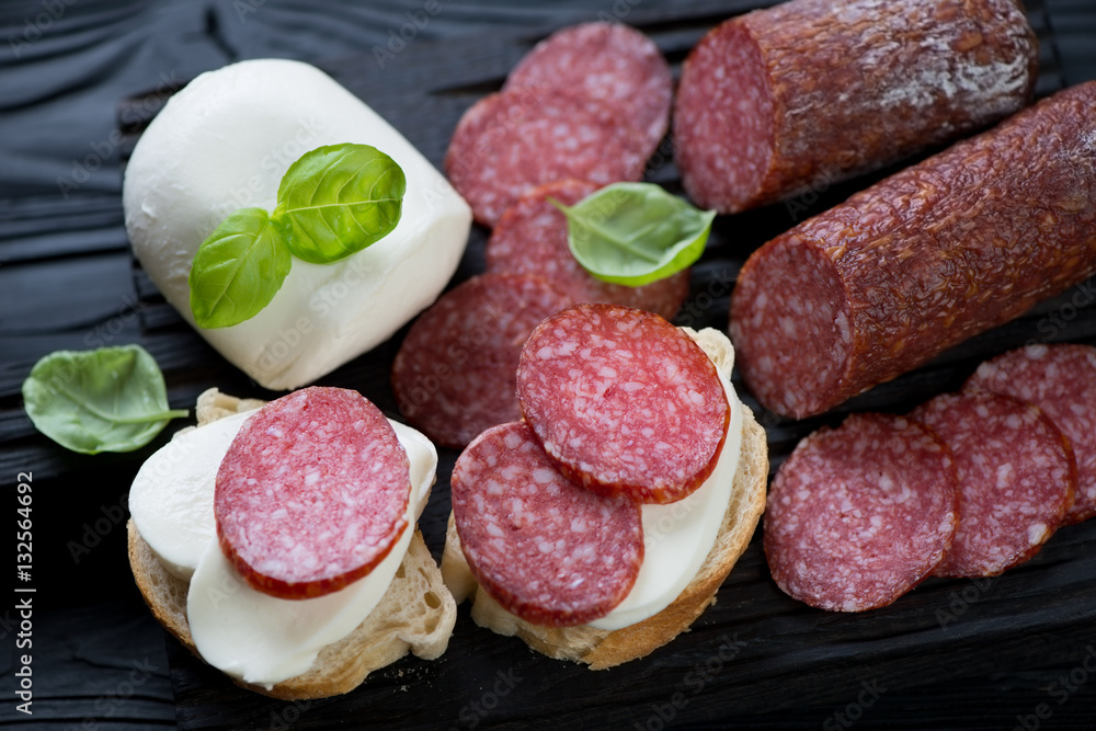 Close-up of italian bruschetta with salami and mozzarella cheese Close-up of italian bruschetta with salami and mozzarella cheese