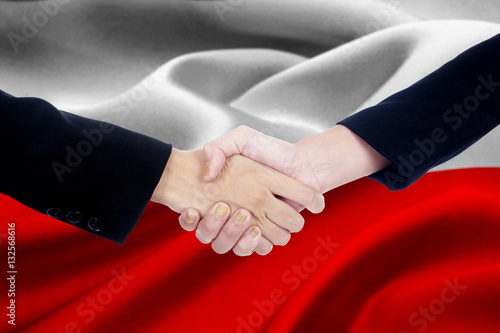 Agreement handshake with flag of Poland