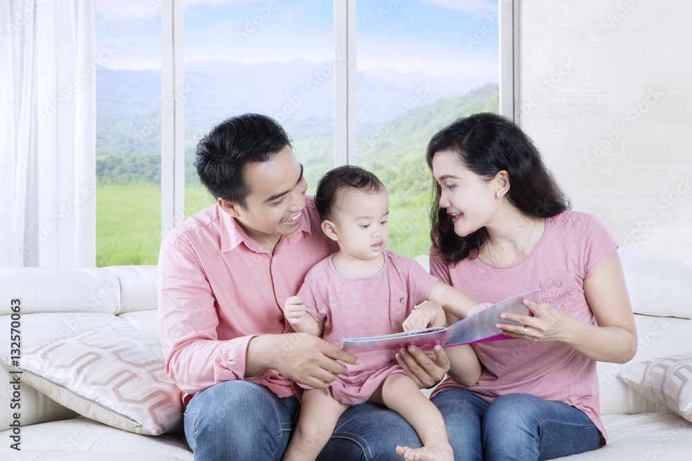 Asian parents reading story tale with daughter Asian parents reading story tale with daughter