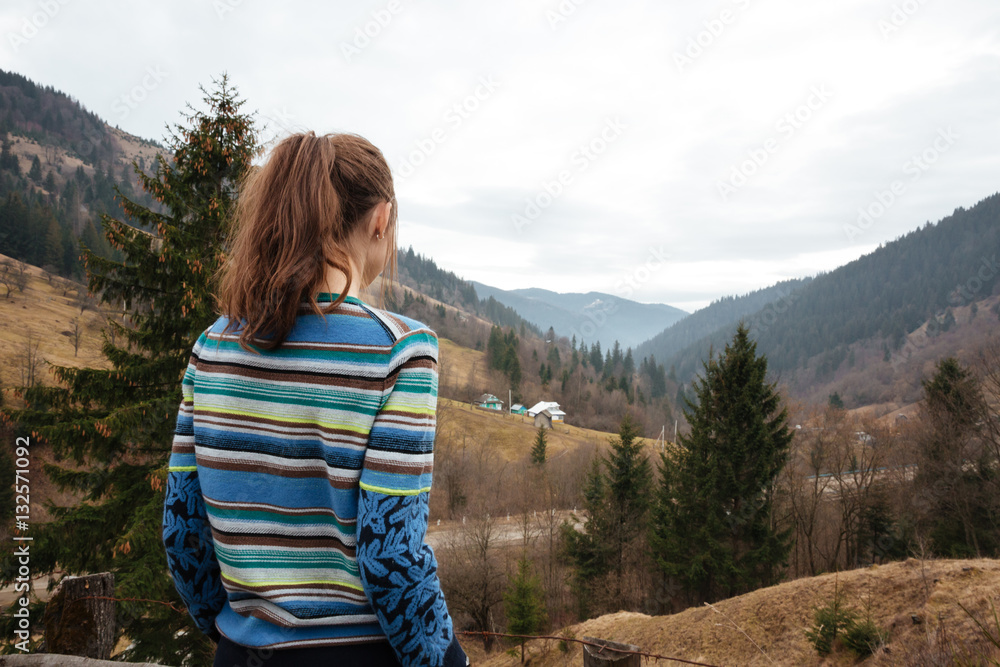 Back view picture of young woman in the mountains. Back view picture of young woman in the mountains.