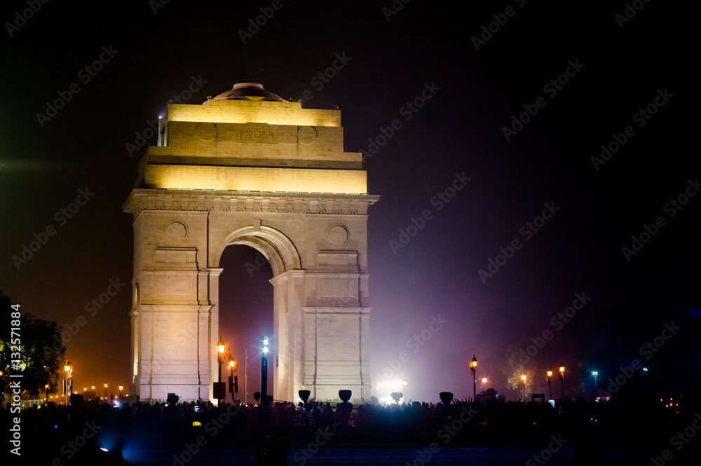 India gate at night with multicolored lights. This landmark is one of the main attractions of Delhi and a popular tourist destination. It was designed by Edwin Luytens