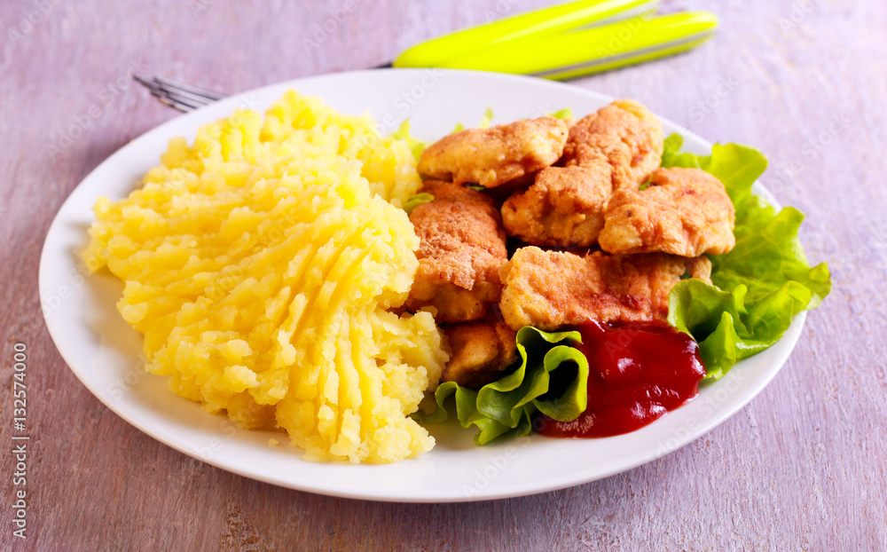 Fototapeta premium Chicken nuggets and mashed potatoes