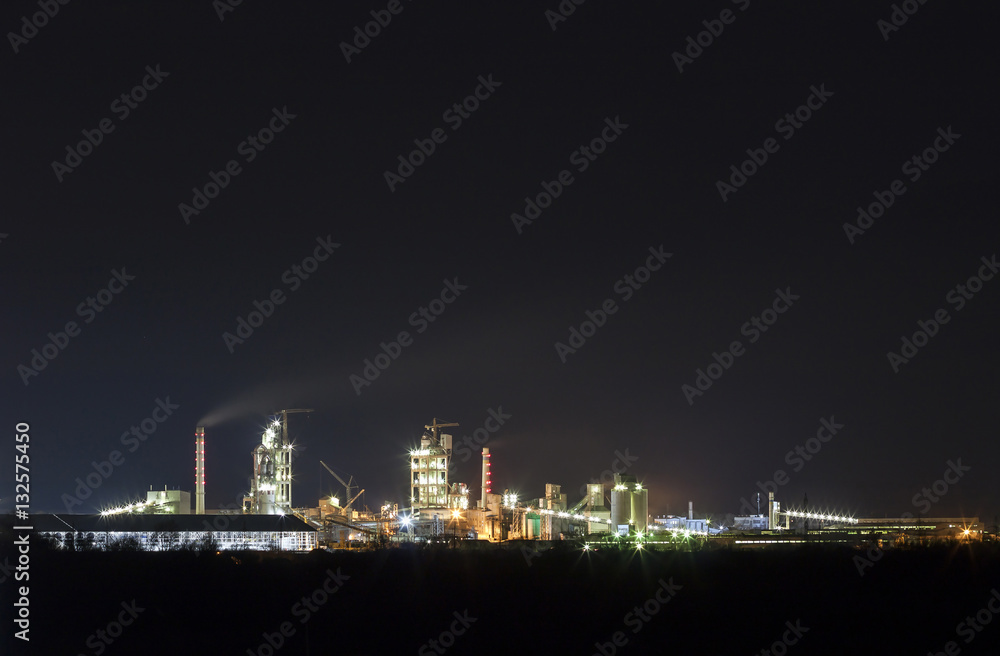 Panorama view of cement plant and power sation at night in Ivano