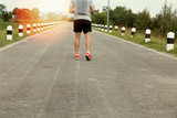 athletic young man running on road in the park. Healthy lifestyl