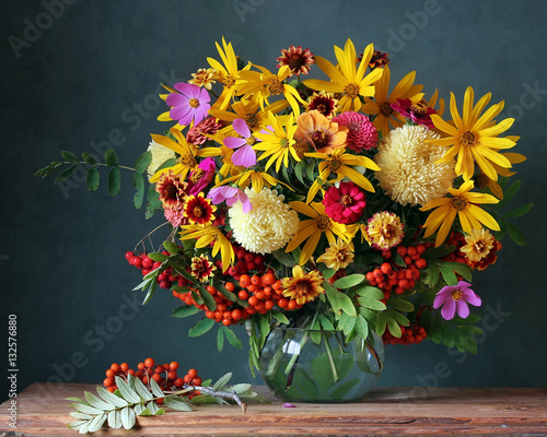 Autumn bouquet with garden flowers and berries.