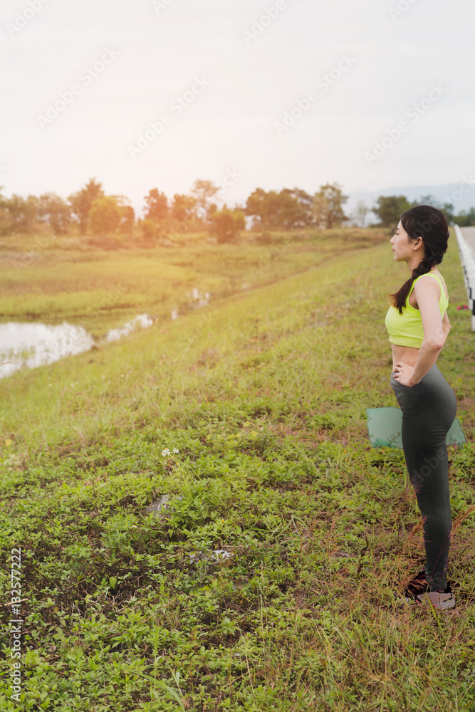young athlete woman exercises outdoor in park,  relax in nature