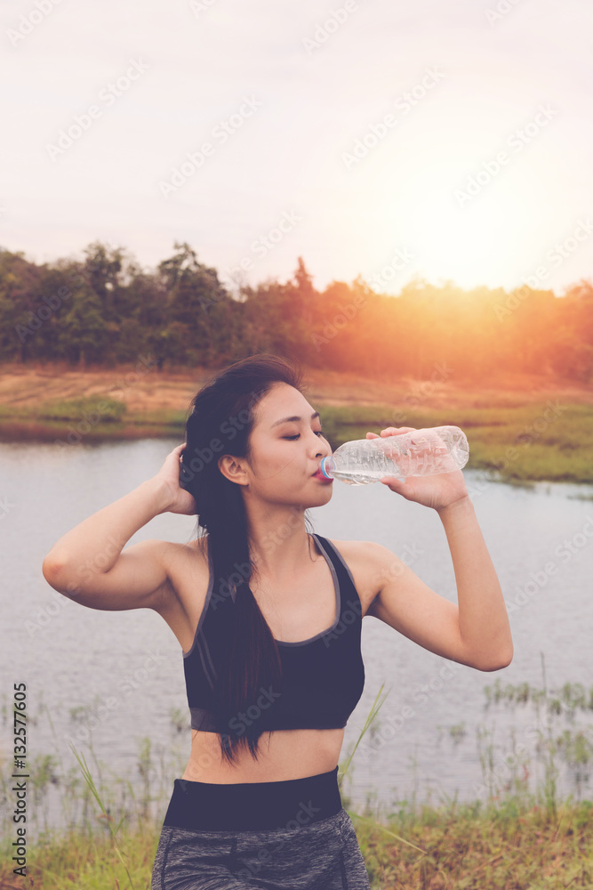 sport and health lifestyle - young woman drinking water from a b sport and health lifestyle - young woman drinking water from a b