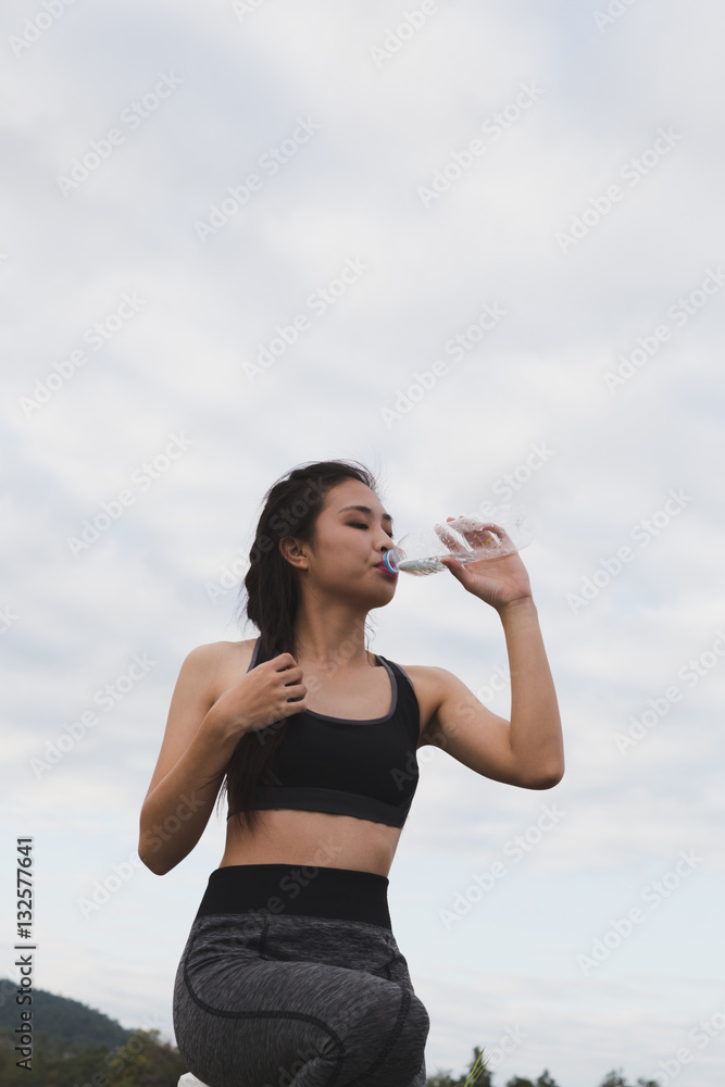 sport and health lifestyle - young woman drinking water from a b sport and health lifestyle - young woman drinking water from a b