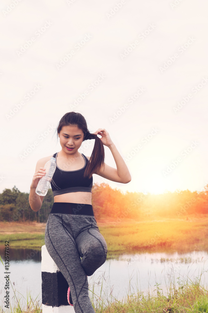 sport and health lifestyle - young woman with bottle of drinking sport and health lifestyle - young woman with bottle of drinking