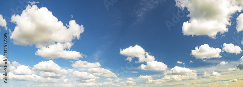 puffy white clouds in the blue sky panorama