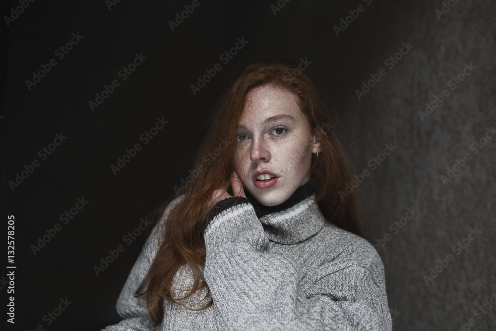 Sensual young model with freckles posing in the dark room Sensual young model with freckles posing in the dark room