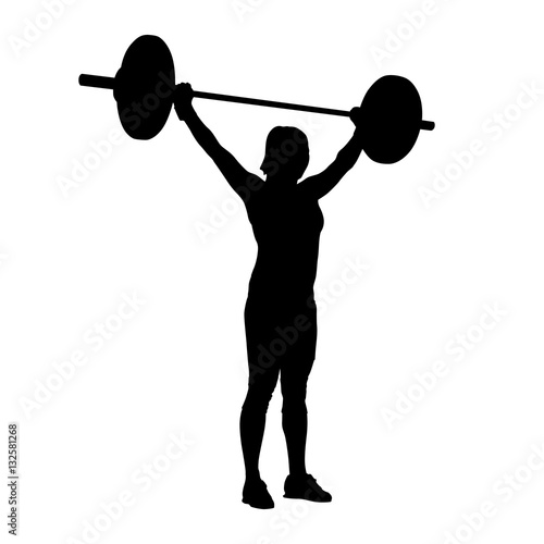 Woman standing and holding barbell over her head. Bodybuilding,
