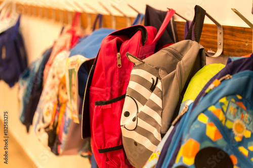 Children's backpacks weigh on hangers in kindergarten