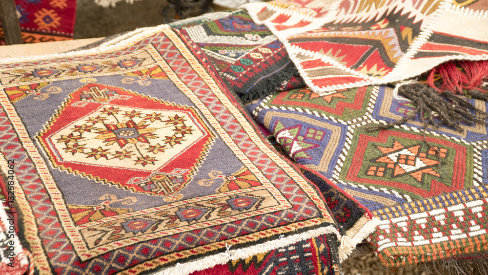 Pile of beautiful handmade carpets on the open market bazaar. Turkish traditional design. Pile of beautiful handmade carpets on the open market bazaar. Turkish traditional design.