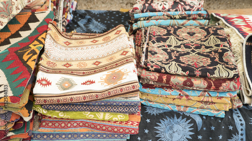 Pile of beautiful handmade carpets on the open market bazaar. Turkish traditional design.