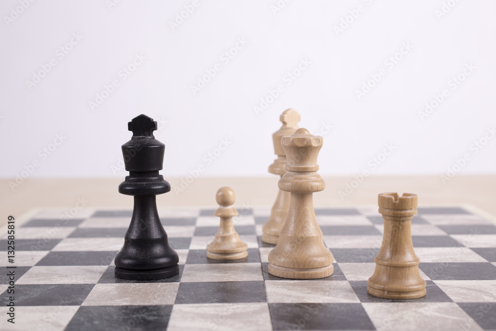 mixed black and white wooden chesspieces on chessboard mixed black and white wooden chesspieces on chessboard