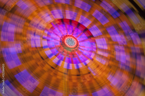 Dynamic colors of a spinning fairground attraction with beautiful colors