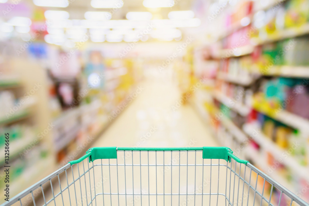 Supermarket aisle with shopping cart blur background