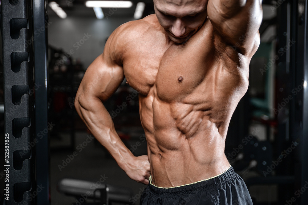 Handsome fitness model train in the gym gain muscle Handsome fitness model train in the gym gain muscle