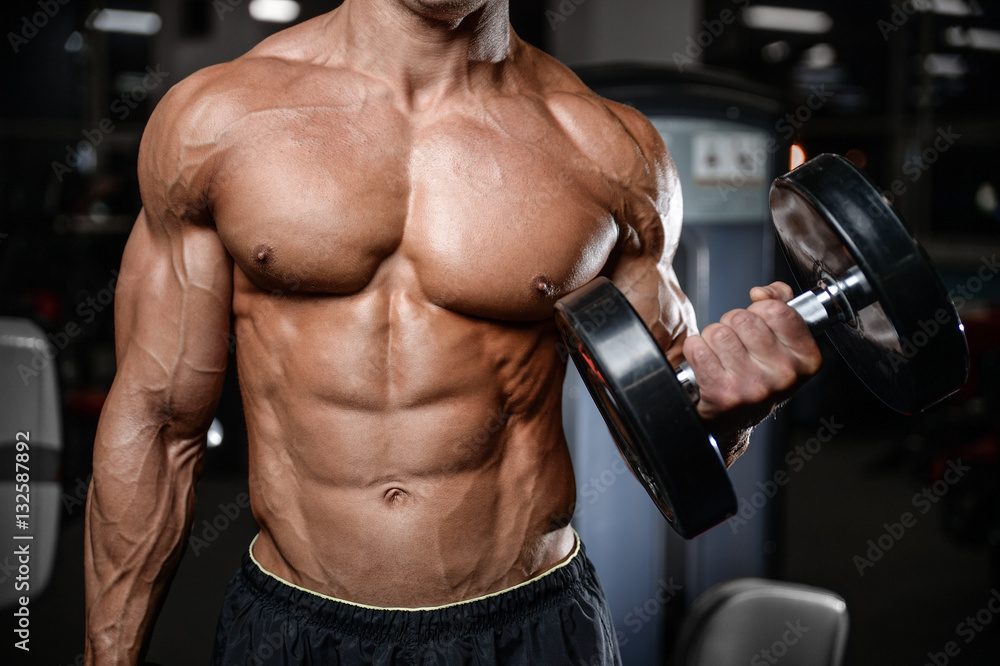 Handsome fitness model train in the gym gain muscle Handsome fitness model train in the gym gain muscle