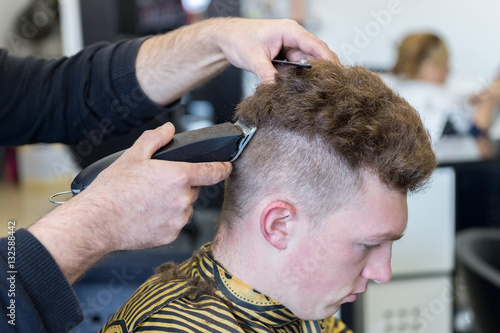 young man on a haircut in the barber shop
