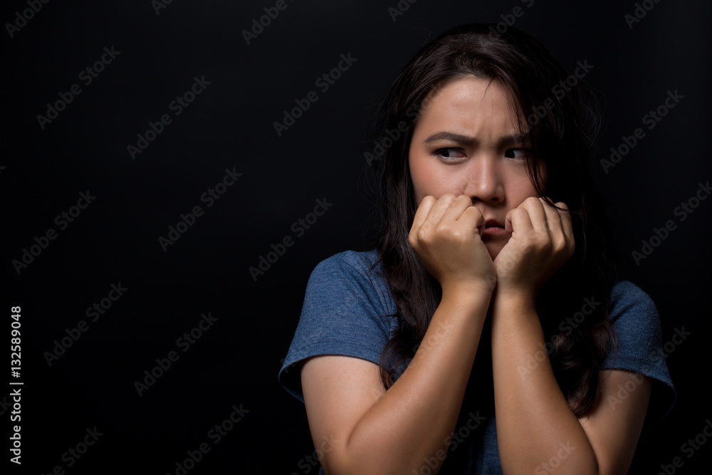 Scared woman on isolated black background Scared woman on isolated black background