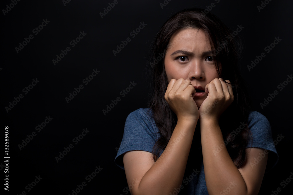 Shocked woman on isolated black background